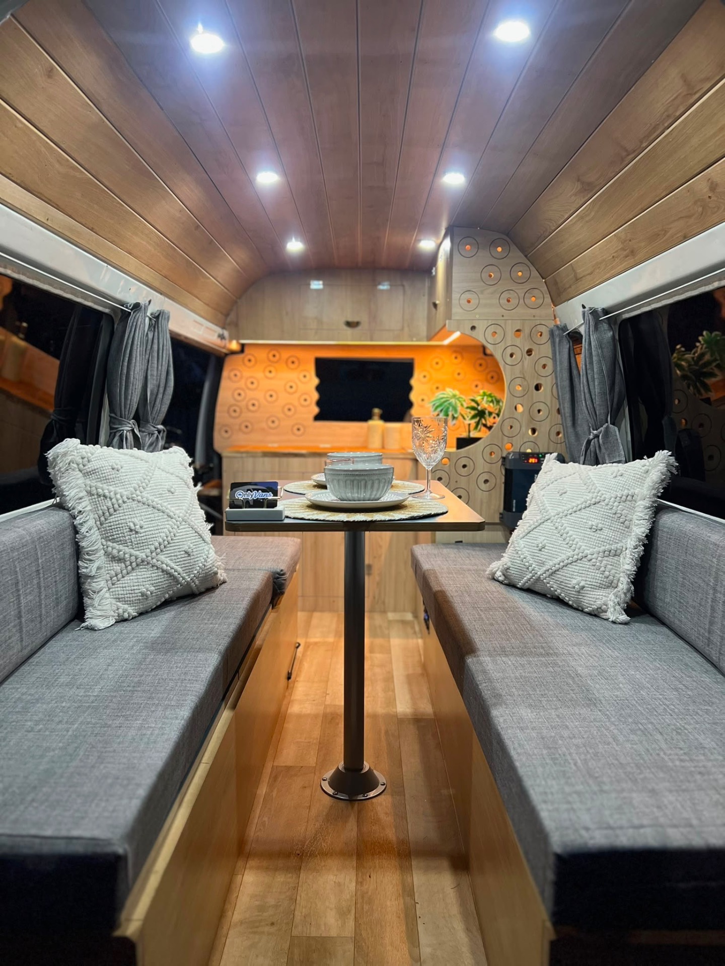 Long dinette shot with timber ceiling, evening lights on